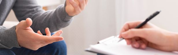 Patient talking to doctor taking notes